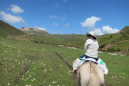 Galloping around the mountains in Langmusi, Gansu Province, China